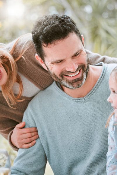 mother and father smiling looking at daughter.